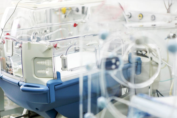 Newborn baby in hospital incubator