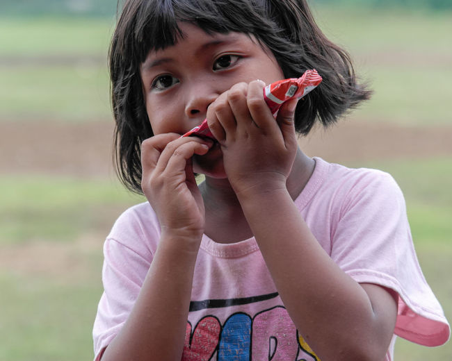 Close-up of young woman drinking water