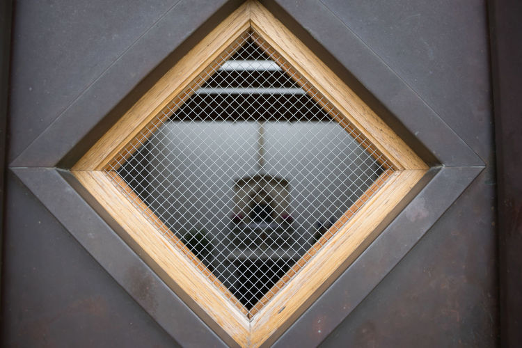 Close-up view trough window into little chapel