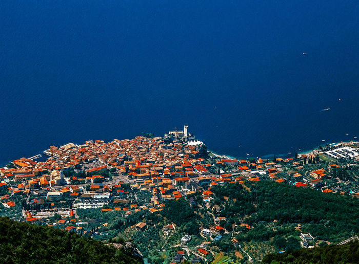 Panorama on malcesine from baldo mountain ridge, garda lake, trentino, italy