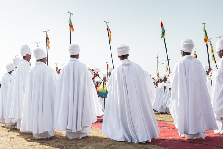 People standing on land against sky during ceremony