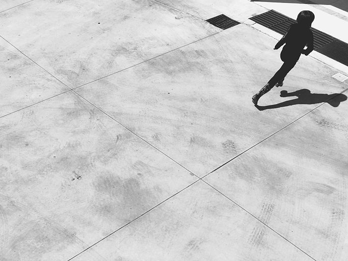 Low section of man walking on skateboard