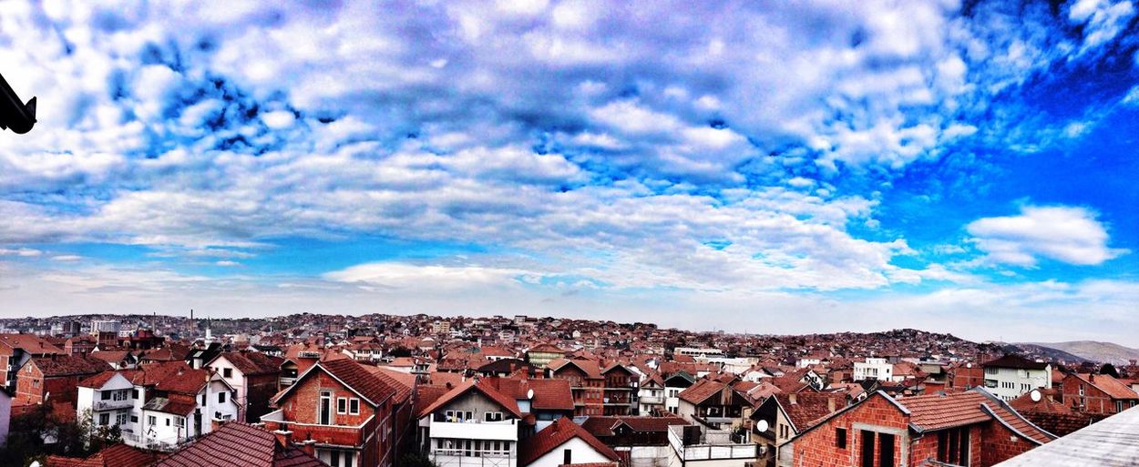 Cityscape against cloudy sky