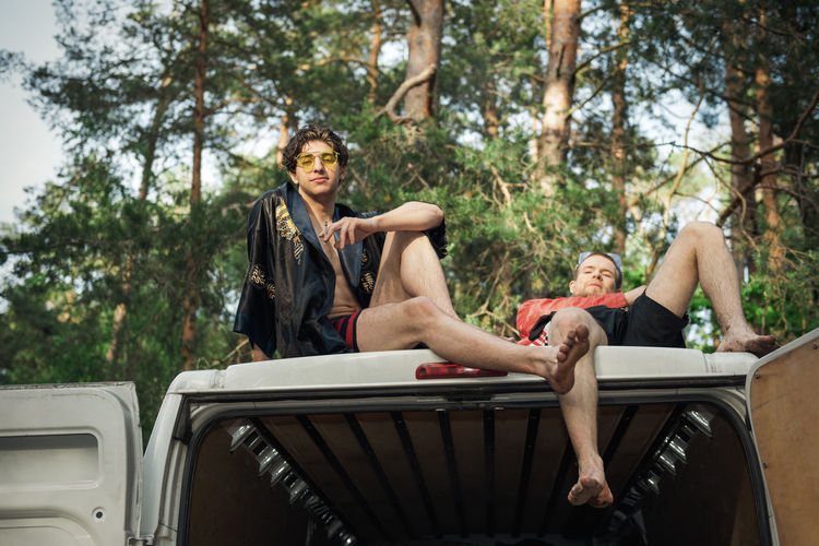 Low angle view of men sitting on truck