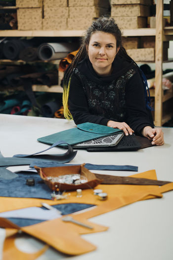 Portrait of smiling young woman standing on table