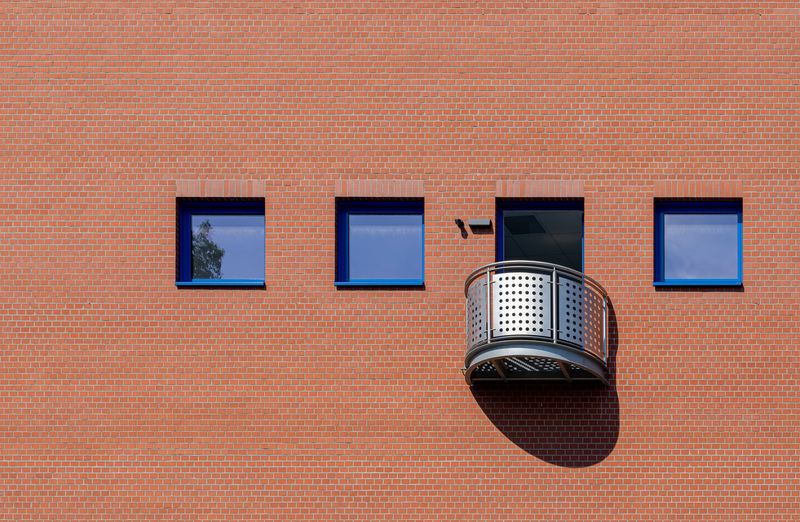 Close-up of microphone against brick wall
