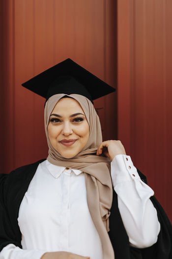 Portrait of woman wearing graduation hat
