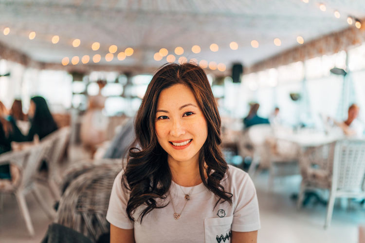 Portrait of a smiling young woman in restaurant