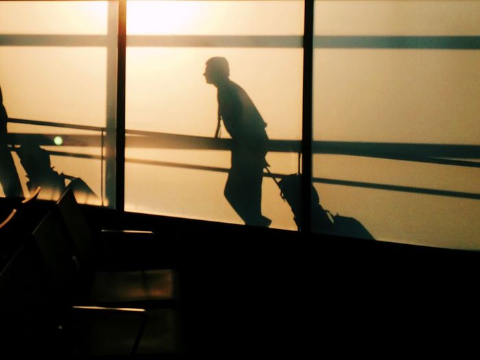 Side view of silhouette man walking at john f kennedy international airport