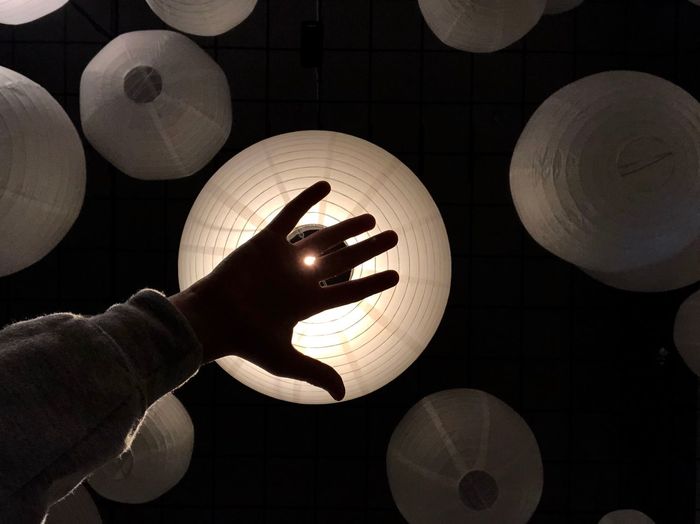 High angle view of hand holding illuminated lamp