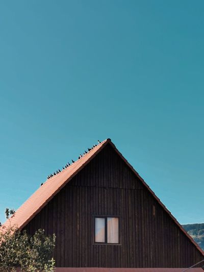 Low angle view of building against clear blue sky