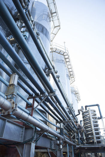 Worker controlling stainless steel tanks for food industry