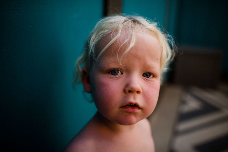 Close up of two year old with turquoise background
