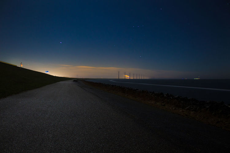 Road against sky at night