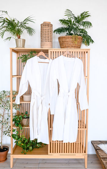 Clothes hanging on bed at home