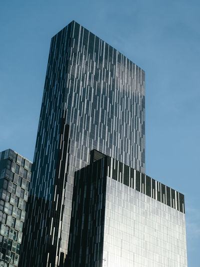 Low angle view of modern glass building against clear sky