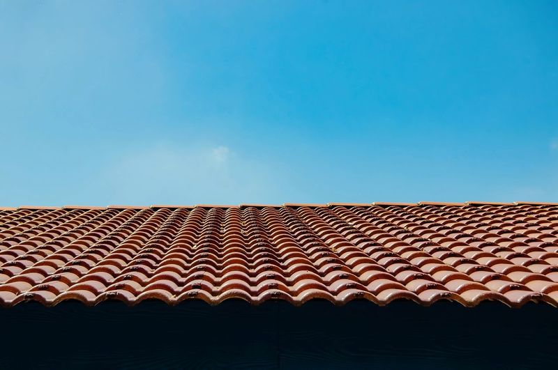 Low angle view of roof against clear blue sky