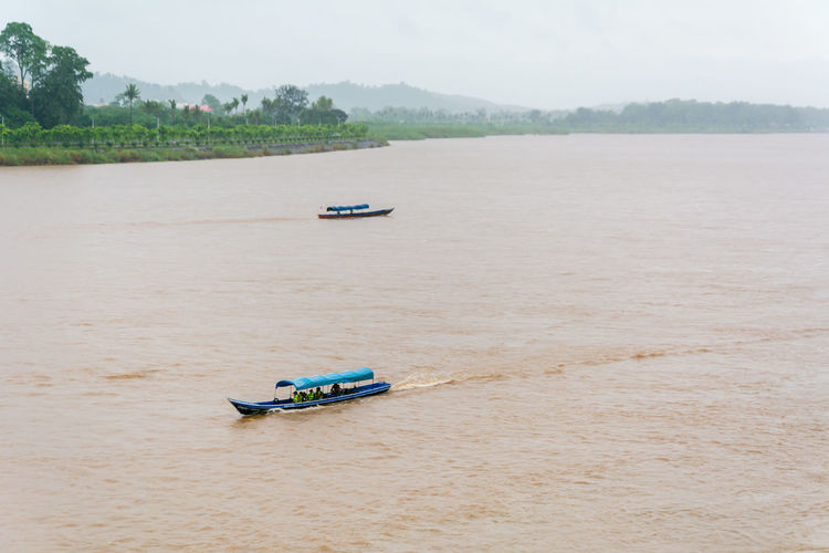 High angle view of boats sailing on river at chiang saen port