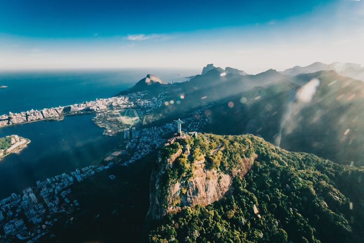Aerial view of sea and mountains against sky