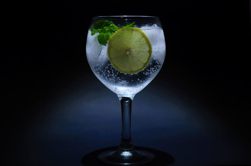 Close-up of drink in glass against black background
