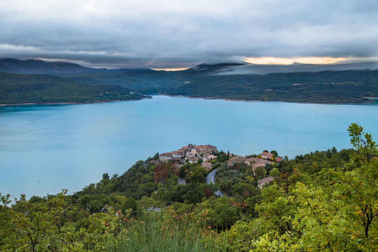 Scenic view of sea and mountains against sky