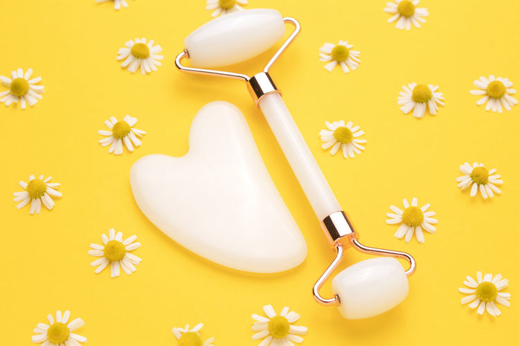 High angle view of spoon with heart shape decoration against yellow background