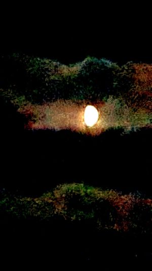 Scenic view of illuminated dark against sky at night