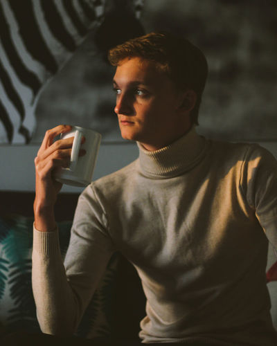 Portrait of man holding coffee cup