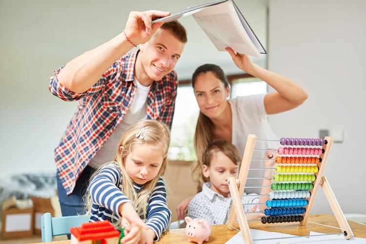 Portrait of cheerful family doing drawing at home