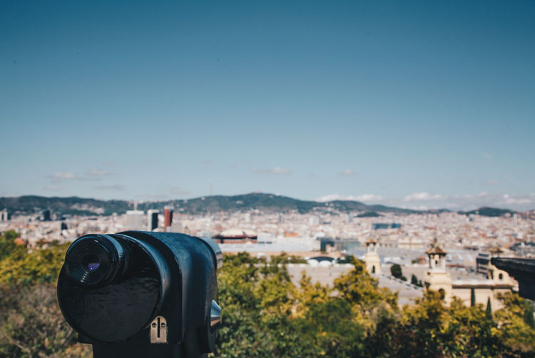 Coin operated binoculars against blue sky