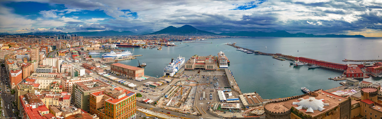 High angle view of townscape by sea against sky