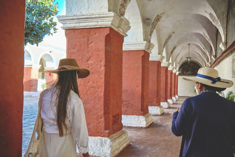 Tourists with a guide in inside the santa catalina monastery. exploring unesco world heritage