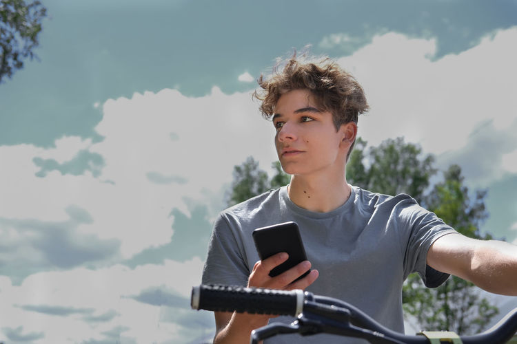 Low angle view of young man using mobile phone