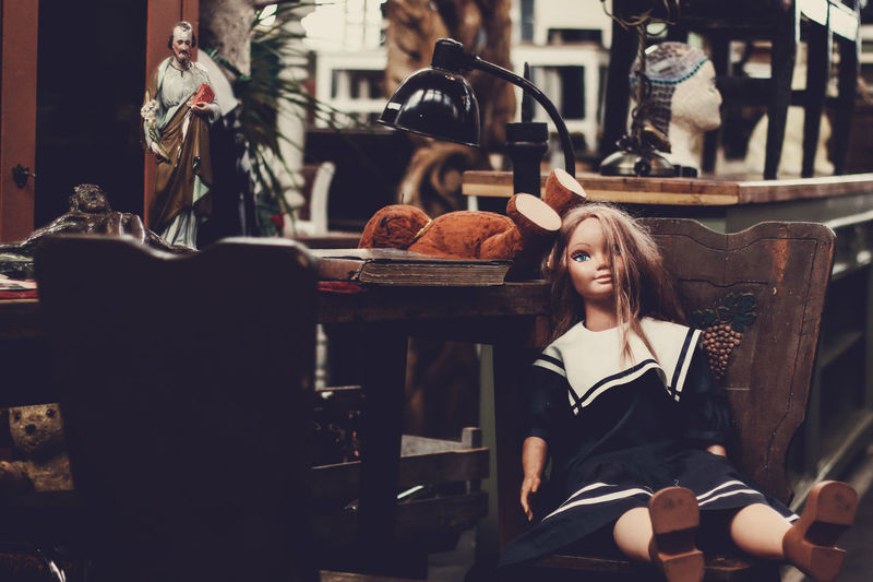 Doll and teddy bear on table