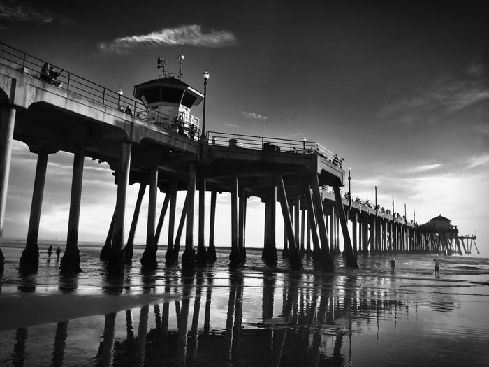Low angle view of huntington beach pier over sea against sky