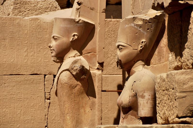 Statues carved on ancient egyptian temple wall