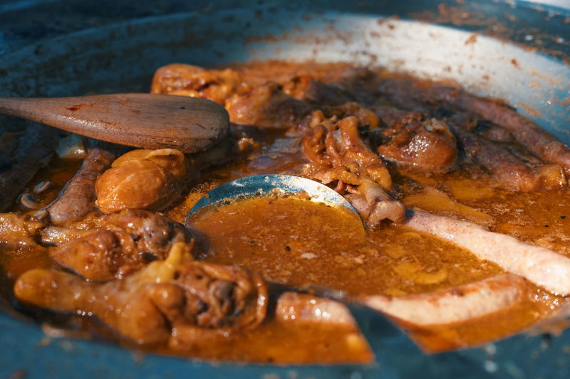 High angle view of pork meat on the barbecue plate
