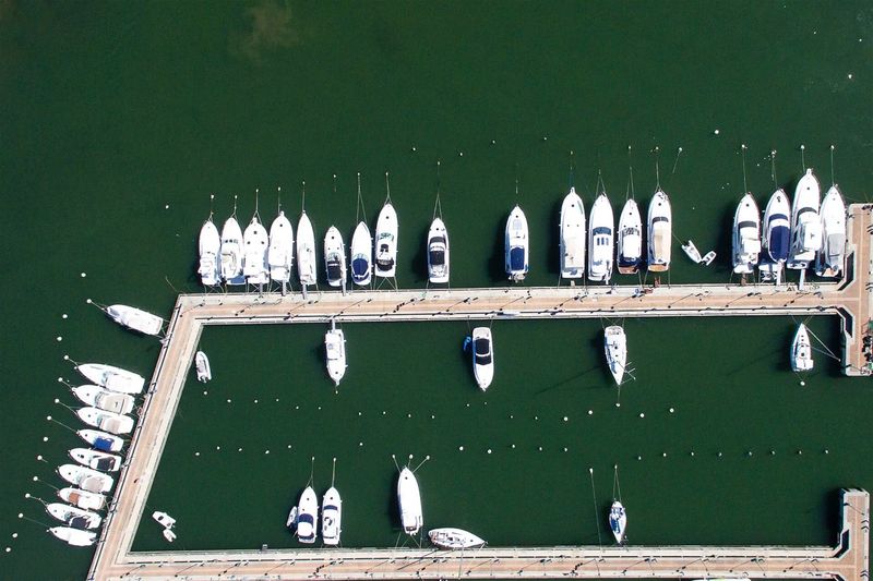 Aerial view of boats on pier at lake