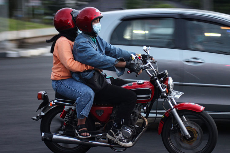 Rear view of man riding motorcycle