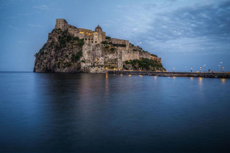 View of aragonese castle at blue hour, ischia, italy