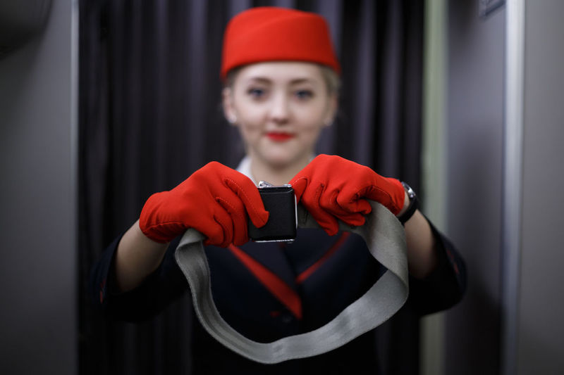 Portrait of air stewardess giving instruction
