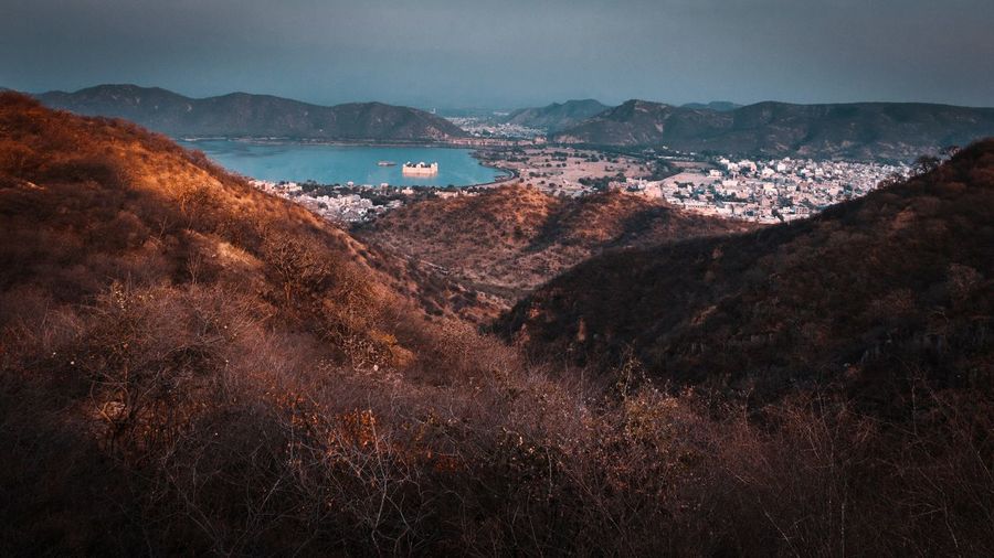 High angle view of cityscape and mountains against sky