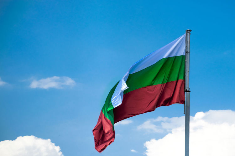 Low angle view of bulgaria flag against blue sky