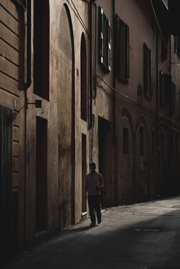Rear view of man walking on street. no oil, sustainable mobility, climate crisis.