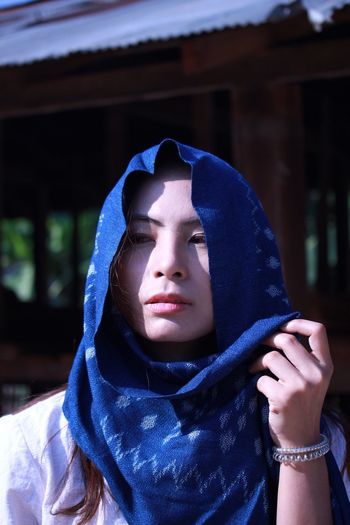 Beautiful young woman looking away while wearing headscarf
