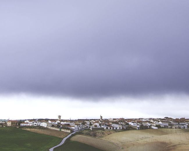 Panoramic view of buildings in city against sky