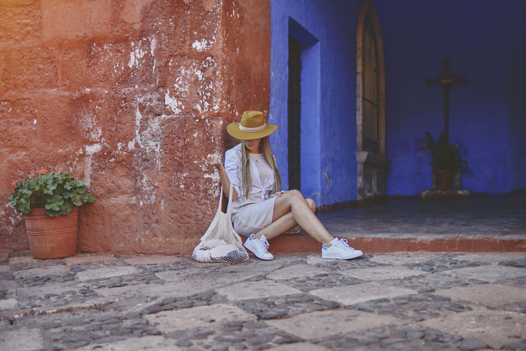 Young tourist resting on the floor in the santa catalina monastery. exploring unesco world heritage