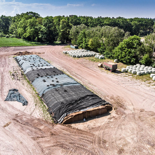 Aerial view of a farm camp, diagonal view of a large silage heap aerial shot