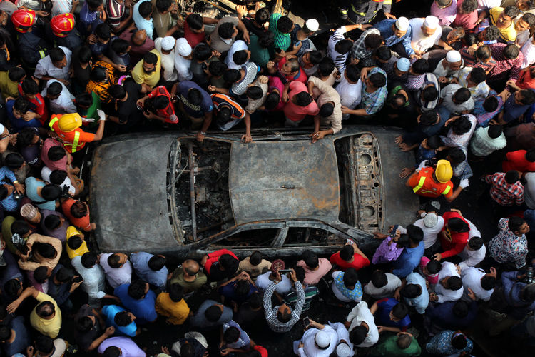 High angle view of group of people and car