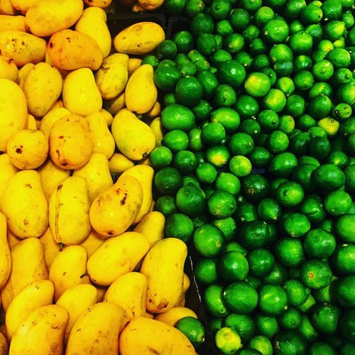 High angle view of mangoes and lemons at market